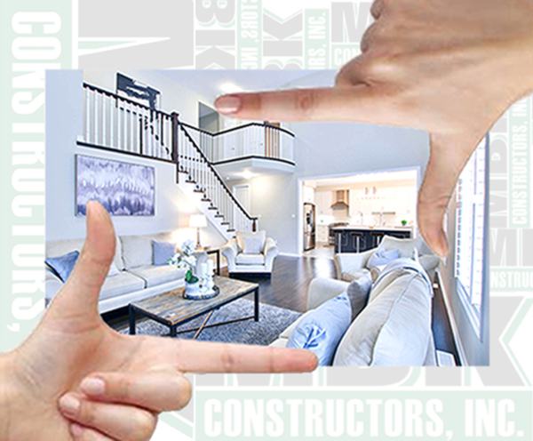 Multiple opaque MBK Constructors, Inc logos with an image of a newly remodeled living room on top of it as well as an image of two hands in L shapes framing the living room image.