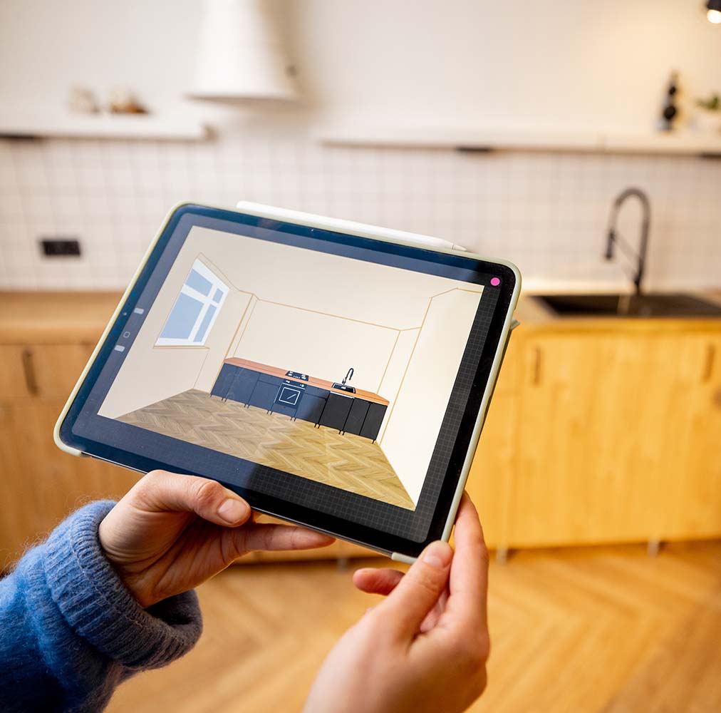 Envisioning home kitchen remodel using software on tablet, a home improvement trend in 2024