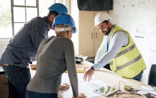 Homeowners and construction worker meet and collaborate to discuss project - Consultations and expanded services help set you apart and meet challenges and opportunities for home improvement in 2024