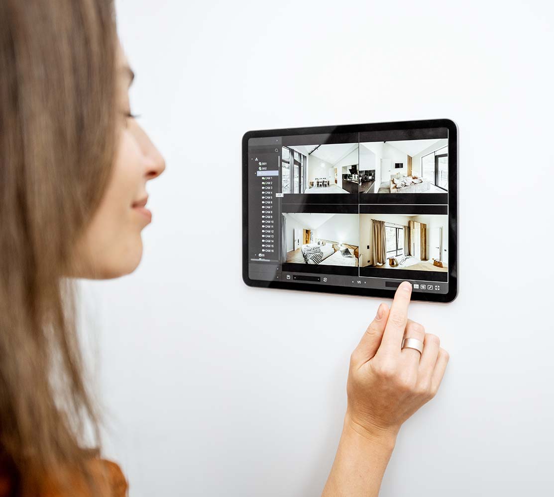 Woman controlling smart home with digital tablet - A trend and opportunity for home improvement in 2024