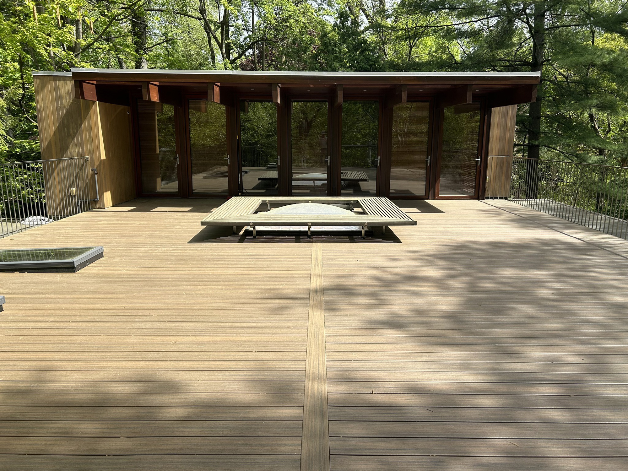 Rooftop deck with sitting area around skylight