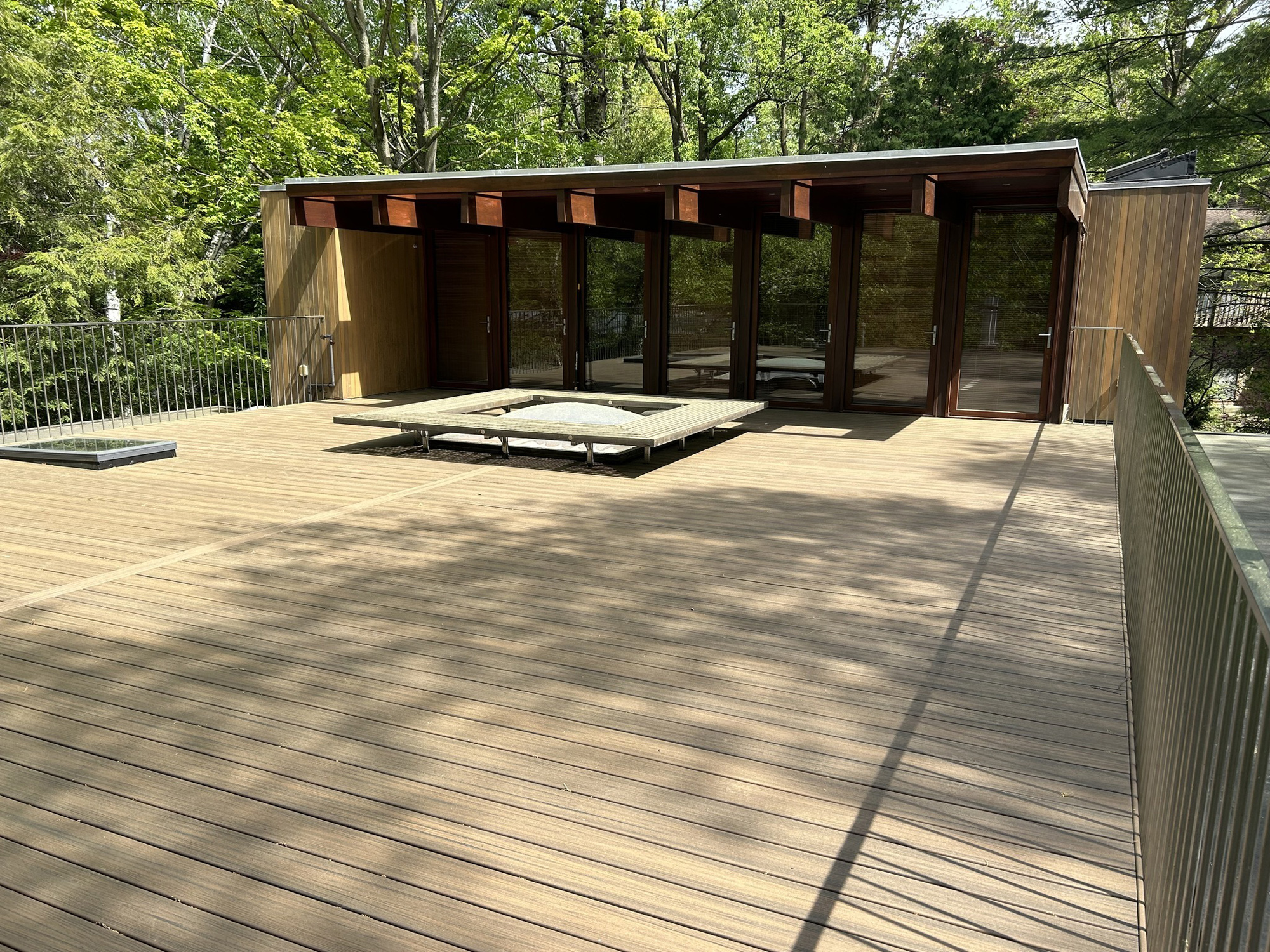 Rooftop deck with sitting area around skylight