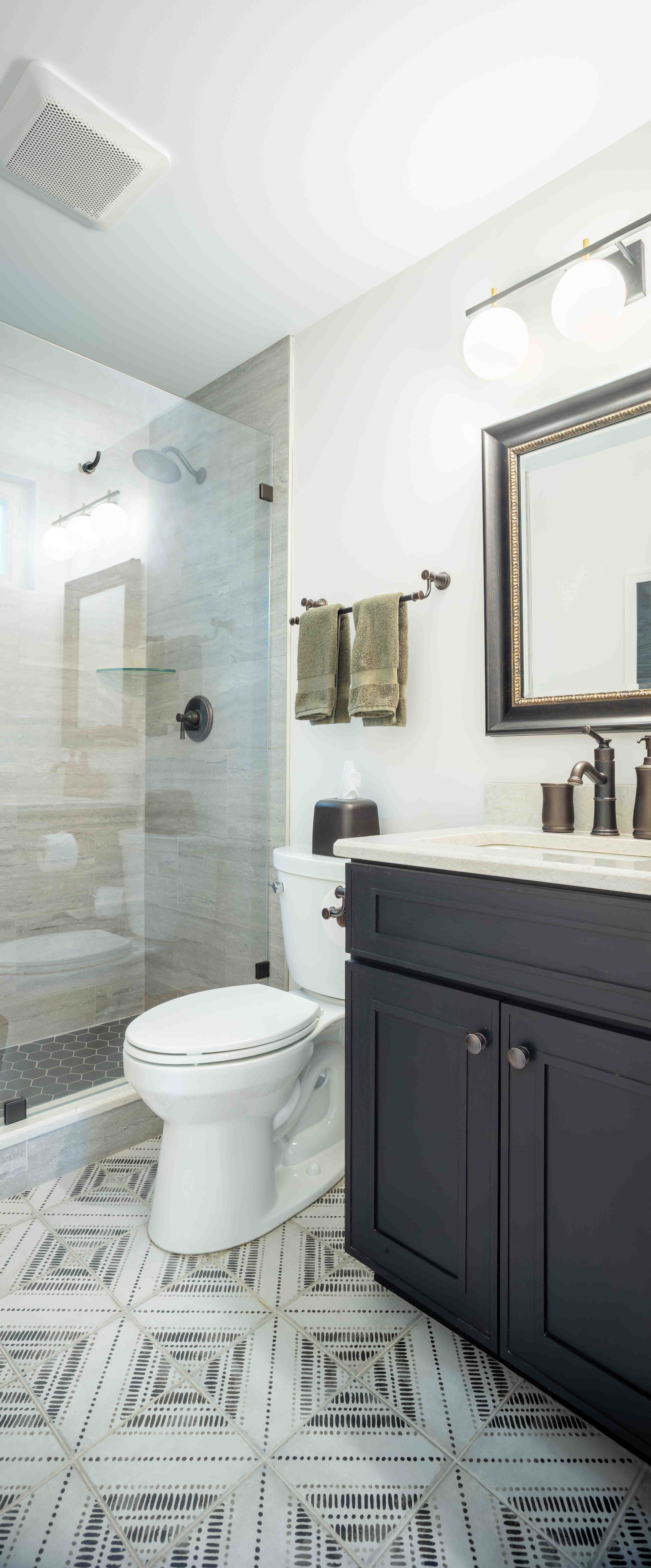 Bathroom vanity, toilet, and walk in shower.